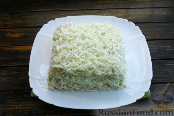 Закусочный торт из крабовых палочек с яйцами, морковью, маринованными огурцами и сыром